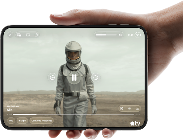 iPhone Duo, held with one hand, opened in horizontal orientation, fully unfolded, interior screen displays Apple TV show “Silo”